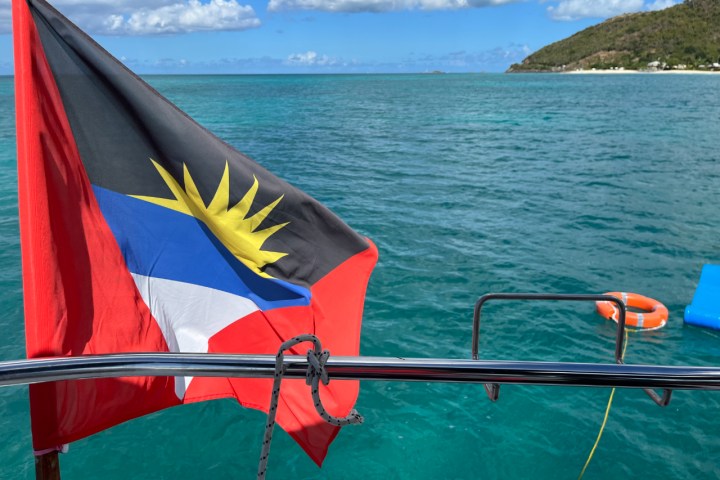 a flag next to a body of water