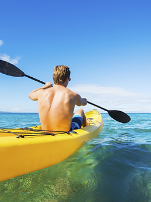 a person riding on the back of a boat in the water